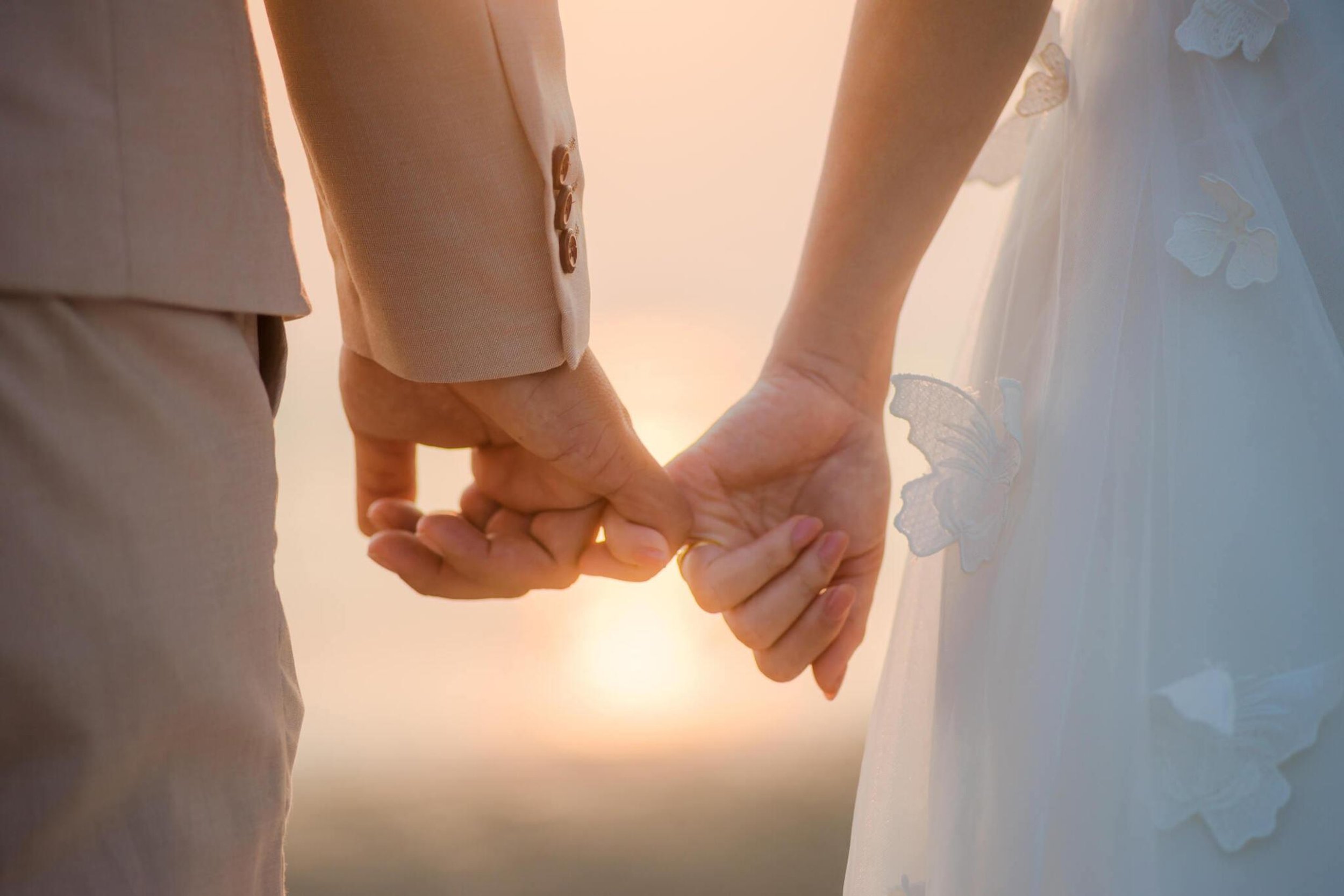 attract your soulmate. image of woman and man with their pinkies intertwined.