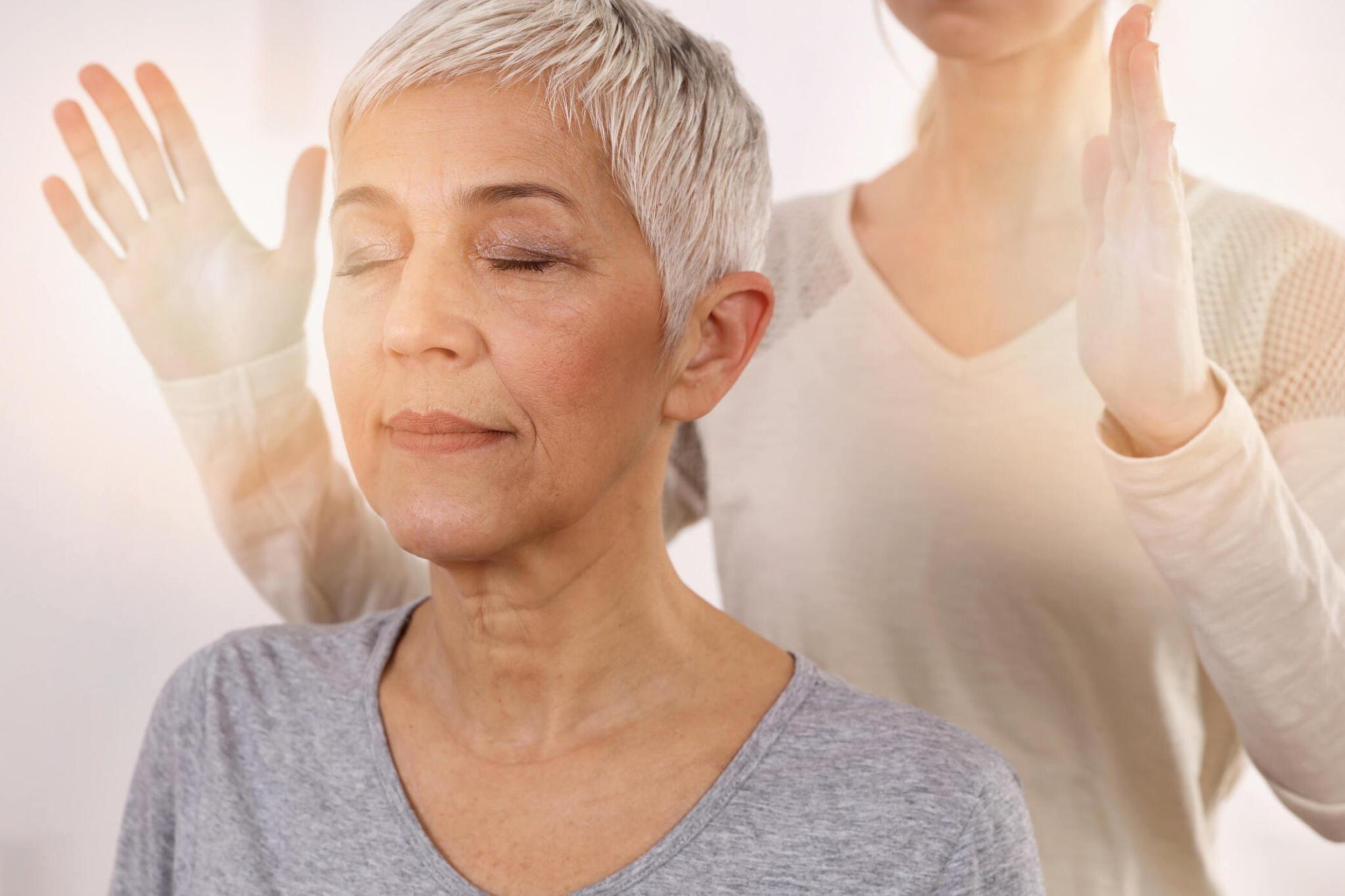 silver haired woman in grey t-shirt receiving a healing session. hypnotherapy in sedona
