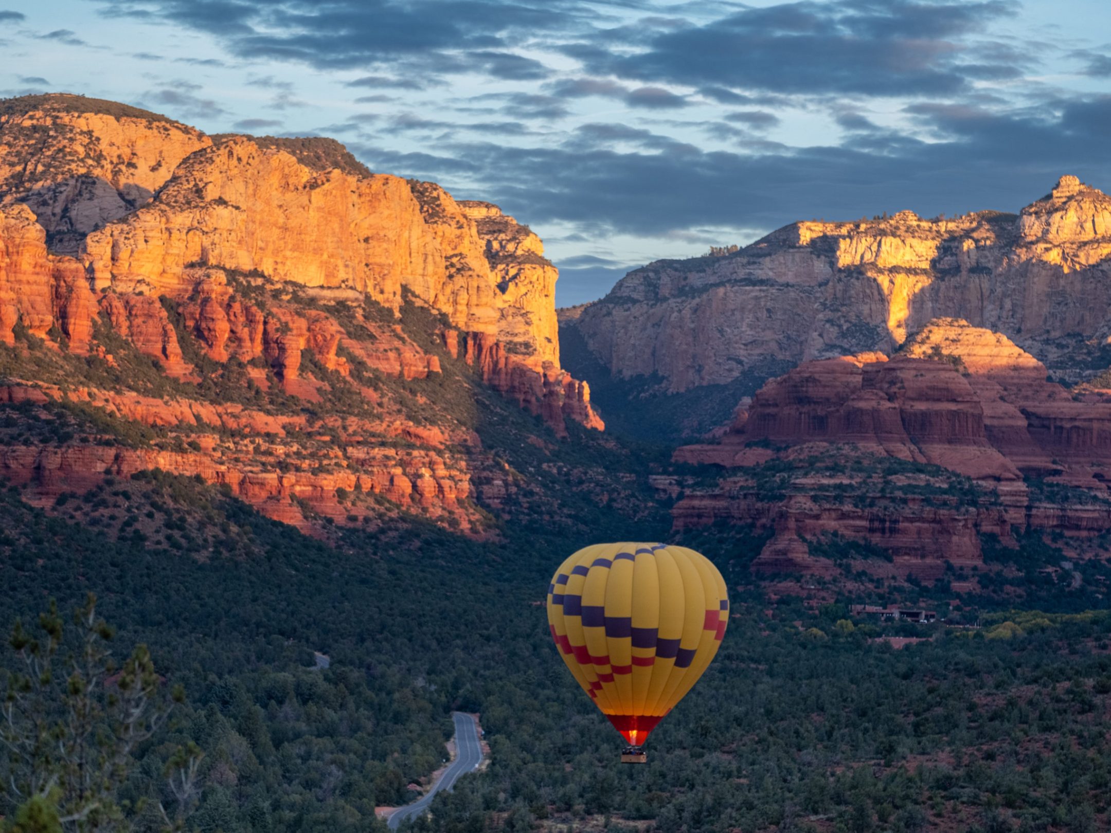 Real hot air balloon flying over the red rocks of Sedona Arizona