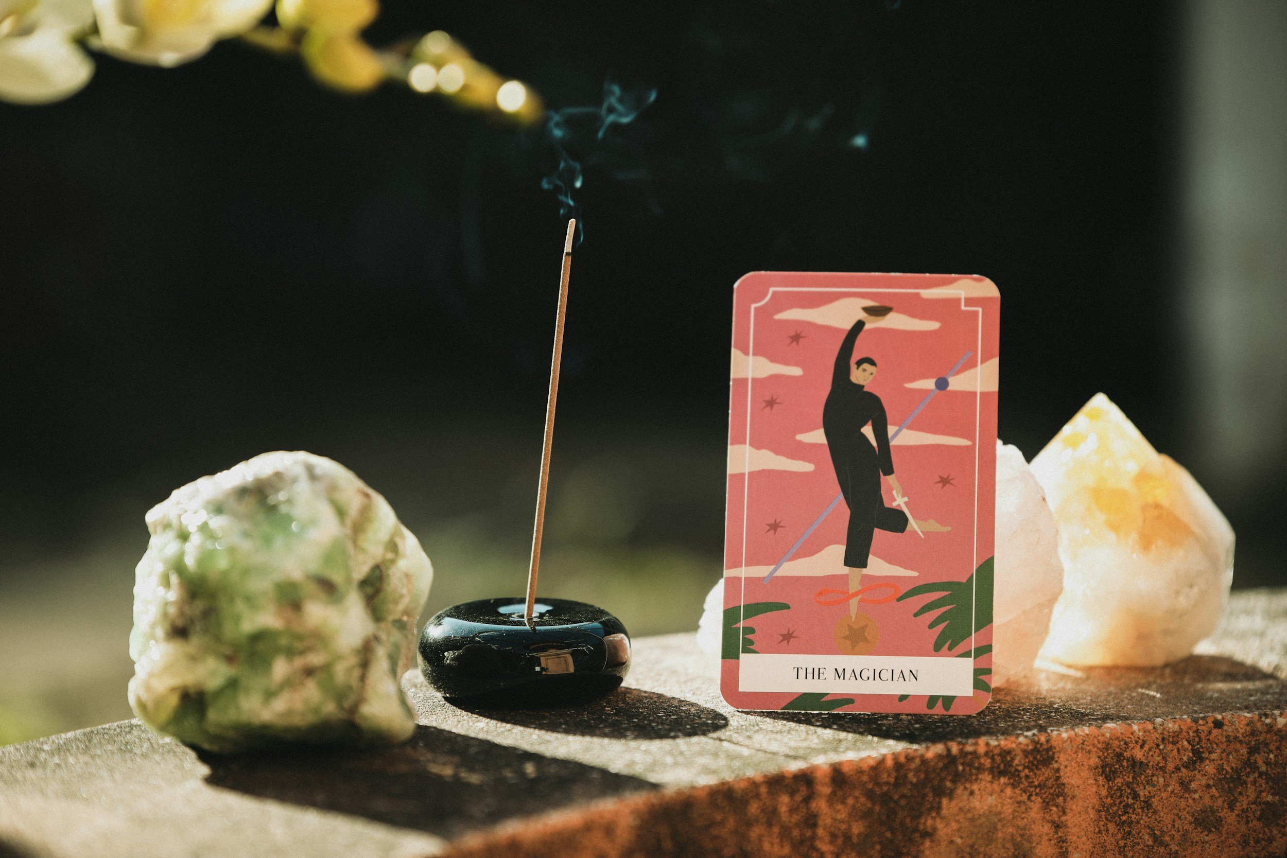 large crystal oracle card and incense burning displayed on table