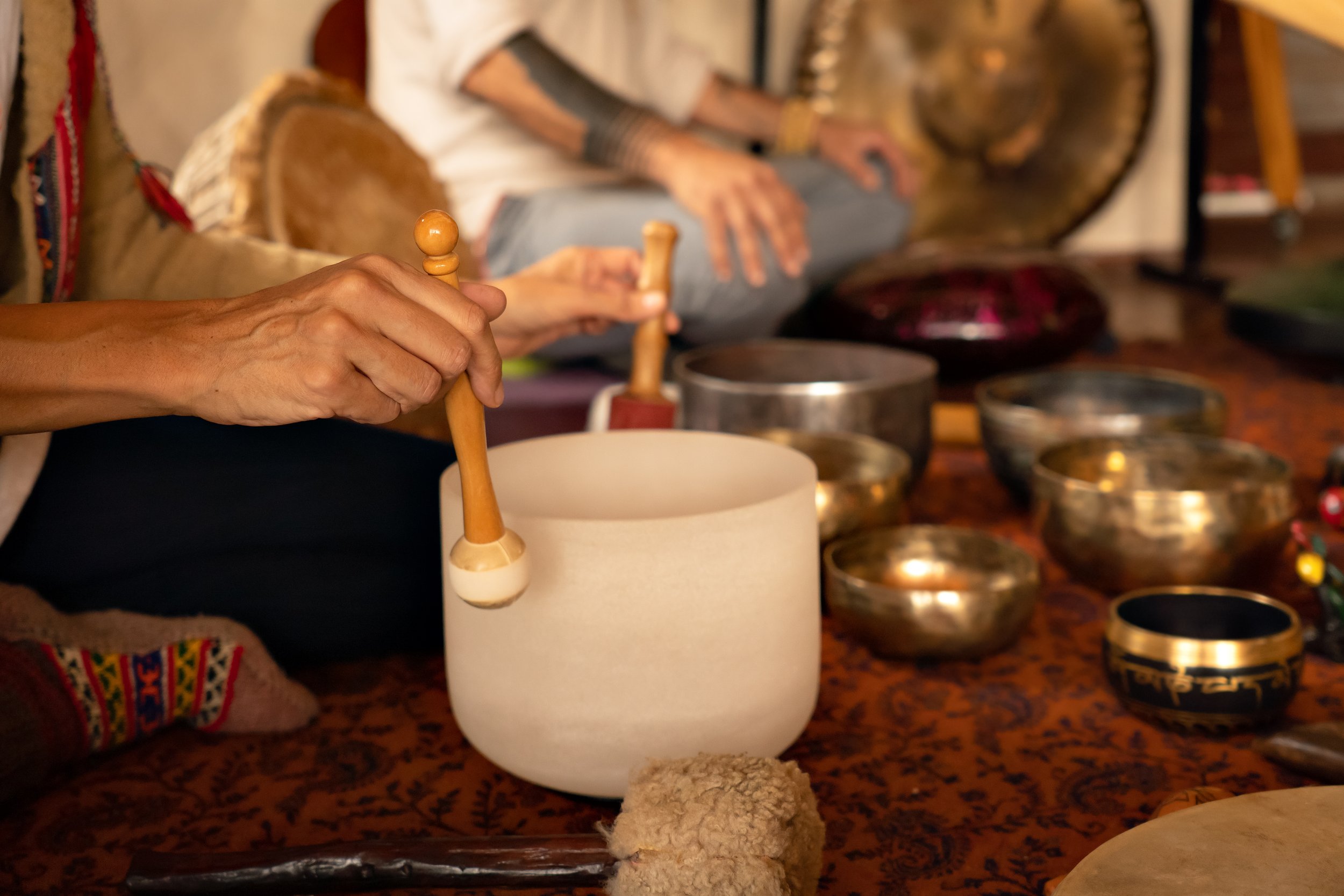 singing bowls with two people sitting cross legged