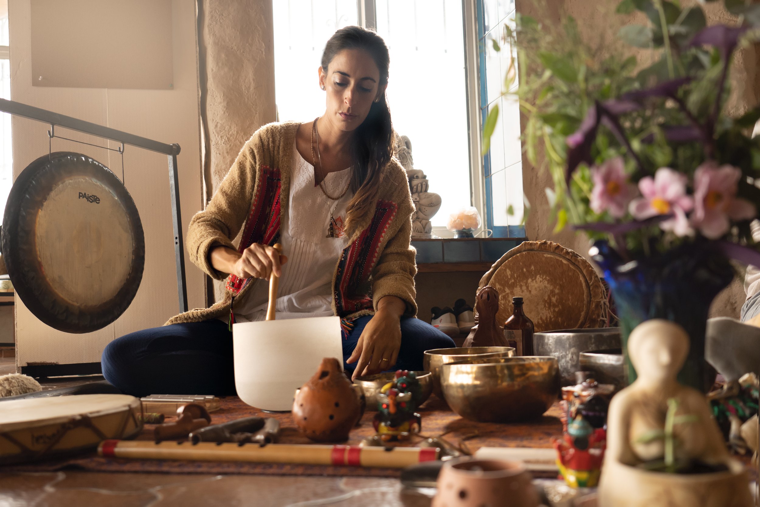 womb healing sound healing woman with gong and singing bowls